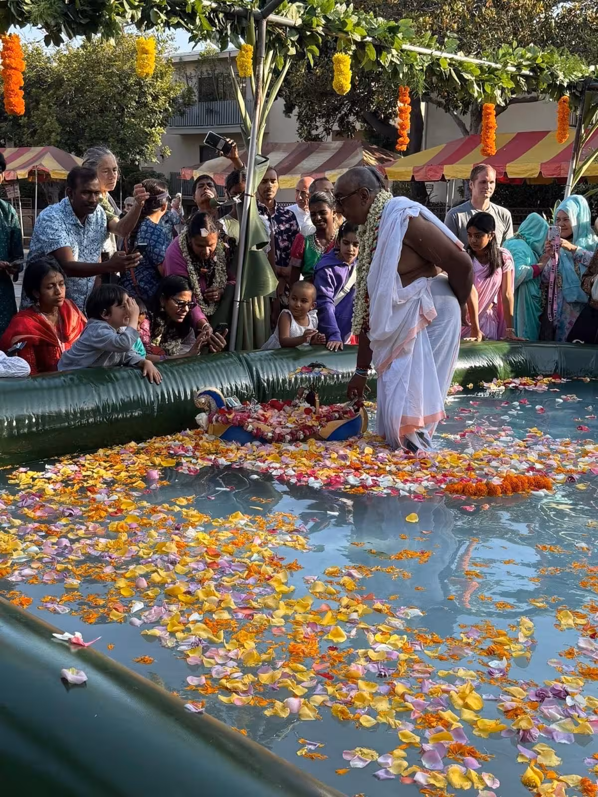 Priest guiding the boat in ceremony