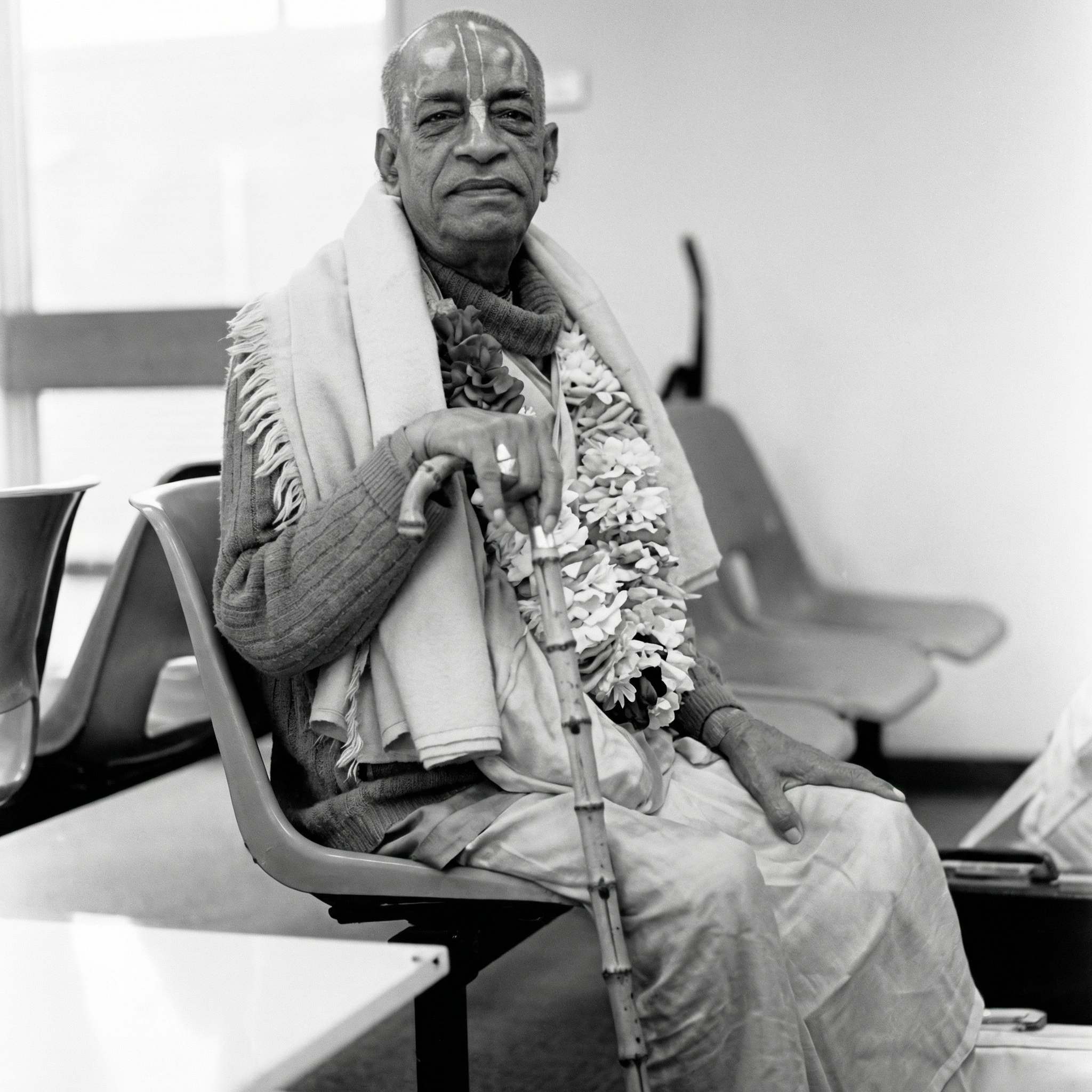 Srila Prabhupada seated with dignified composure during his travels